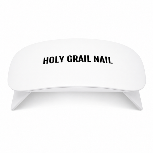 White mini LED lamp for curing semi-cured gel nail wraps, Holy Grail Nail logo.