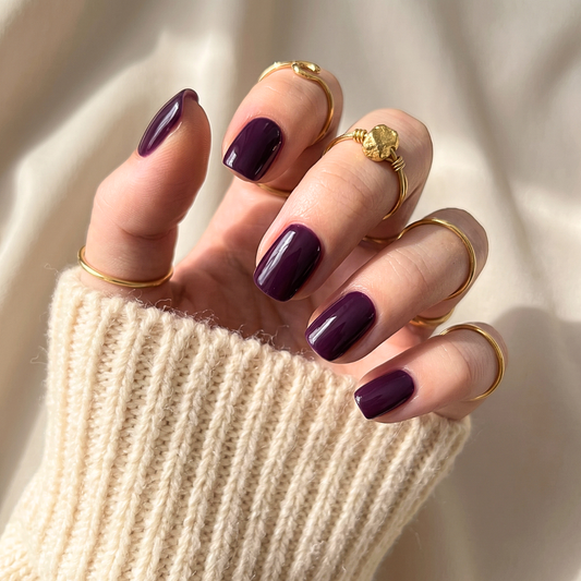 Deep aubergine-purple glossy soft gel press-on nails, extra short natural square shape.