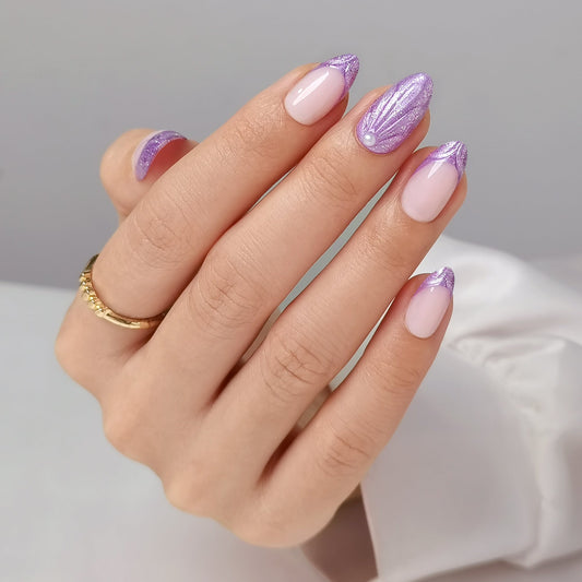 Glittery lilac french tip press-on nails with shimmer shell accent and pearl detail