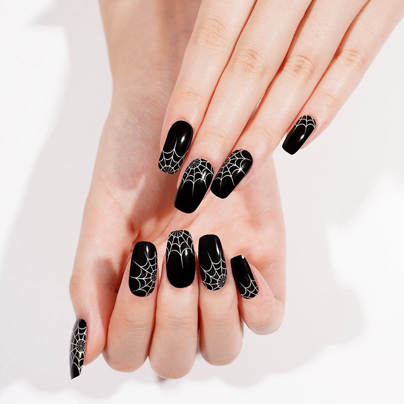 Glossy black semi-cured gel wraps with white spiderweb design on coffin-shaped nails