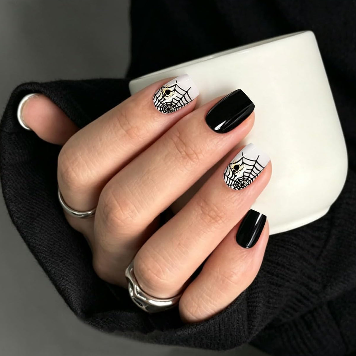 Glossy black and white semi-cured gel wraps with spider web and skull design