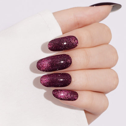 Deep magenta-purple cat-eye semi-cured gel wrap with sparkling glitter shimmer, glossy coffin nails.