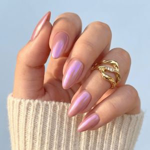 Pink chrome glazed almond press-on nails with glossy metallic finish on hand