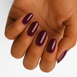 Deep burgundy glossy semi-cured gel nail wraps on almond-shaped nails.