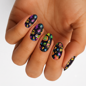 Black semi-cured gel nail wraps with glittery Halloween motifs: pumpkins, skulls, spiders, candy corn.