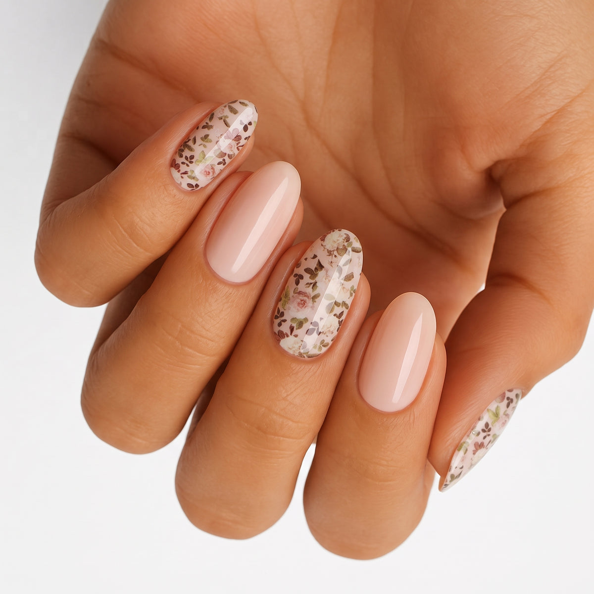 Glossy nude nail wraps with ditsy floral accent nails in soft pink and sage tones