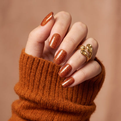 Burnt sienna glitter nail wraps in a glossy square-round shape on short nails