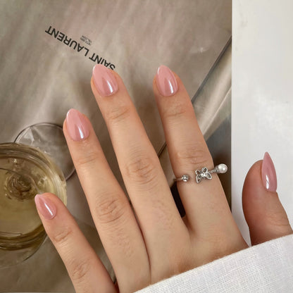 Glossy dusty pink almond-shaped press-on nails, solid sheer color, semi-cured gel finish.