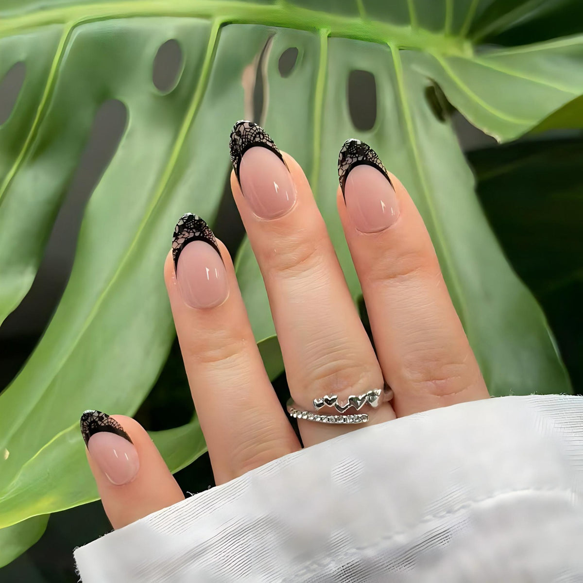 Short almond soft gel press-ons, nude base with black lace French tips
