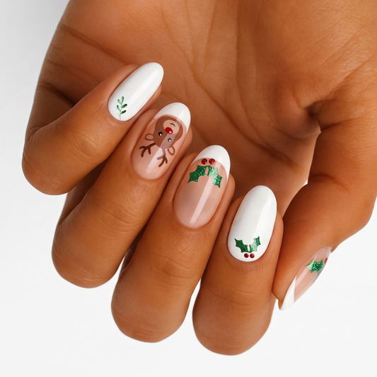 White nail wraps with reindeer face and glittery holly berry mistletoe design on nude French tips