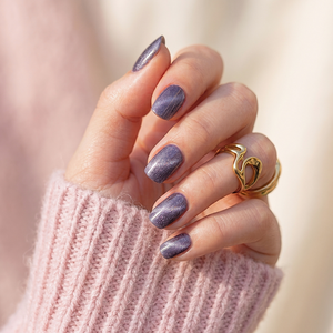 Soft gel press-on nails in dusty purple with shimmering cat's-eye magnetic finish