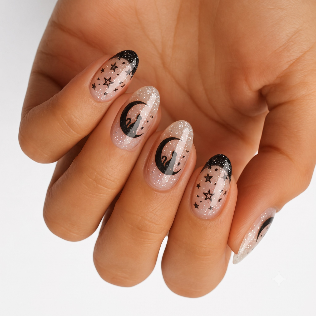 Glittery nude nail wraps with black cat, crescent moon and star designs