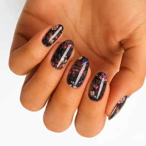Black semi-cured gel nail wraps with pink floral branch design, glossy oval press-on nails