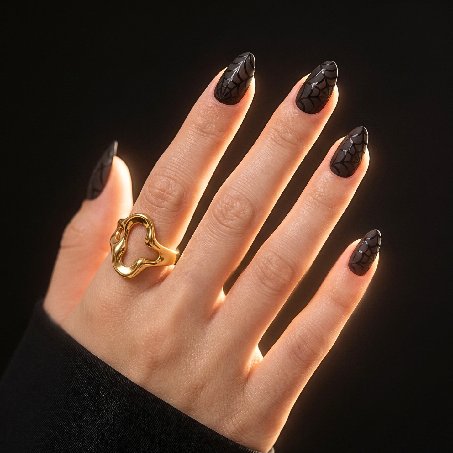 Black glossy semi-cured gel nail wraps with spiderweb design, almond shape, Halloween.