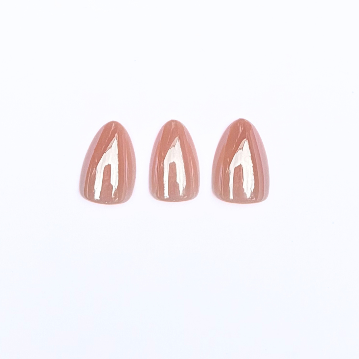 Short almond soft gel press-ons in glossy champagne nude colour