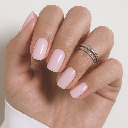 Short square soft gel press-on nails in sheer pale pink with glossy finish