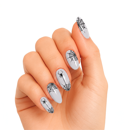 Pale grey semi-cured gel nail wraps with black spiderweb and spider Halloween design