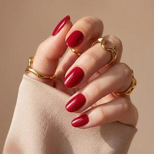 Short oval soft gel press-on nails in glossy deep red, solid colour finish.