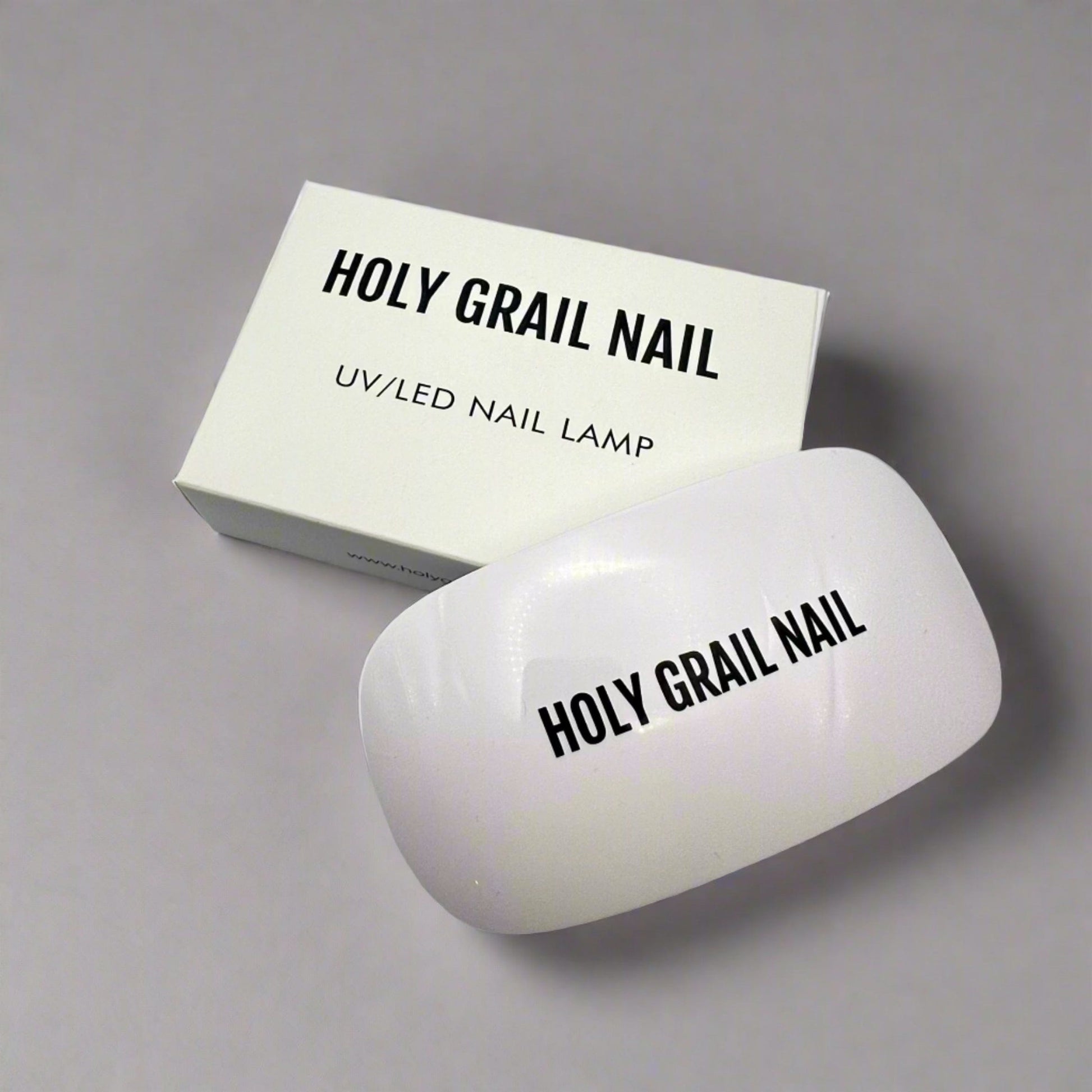 White nail curing lamp next to product box for at-home gel manicures