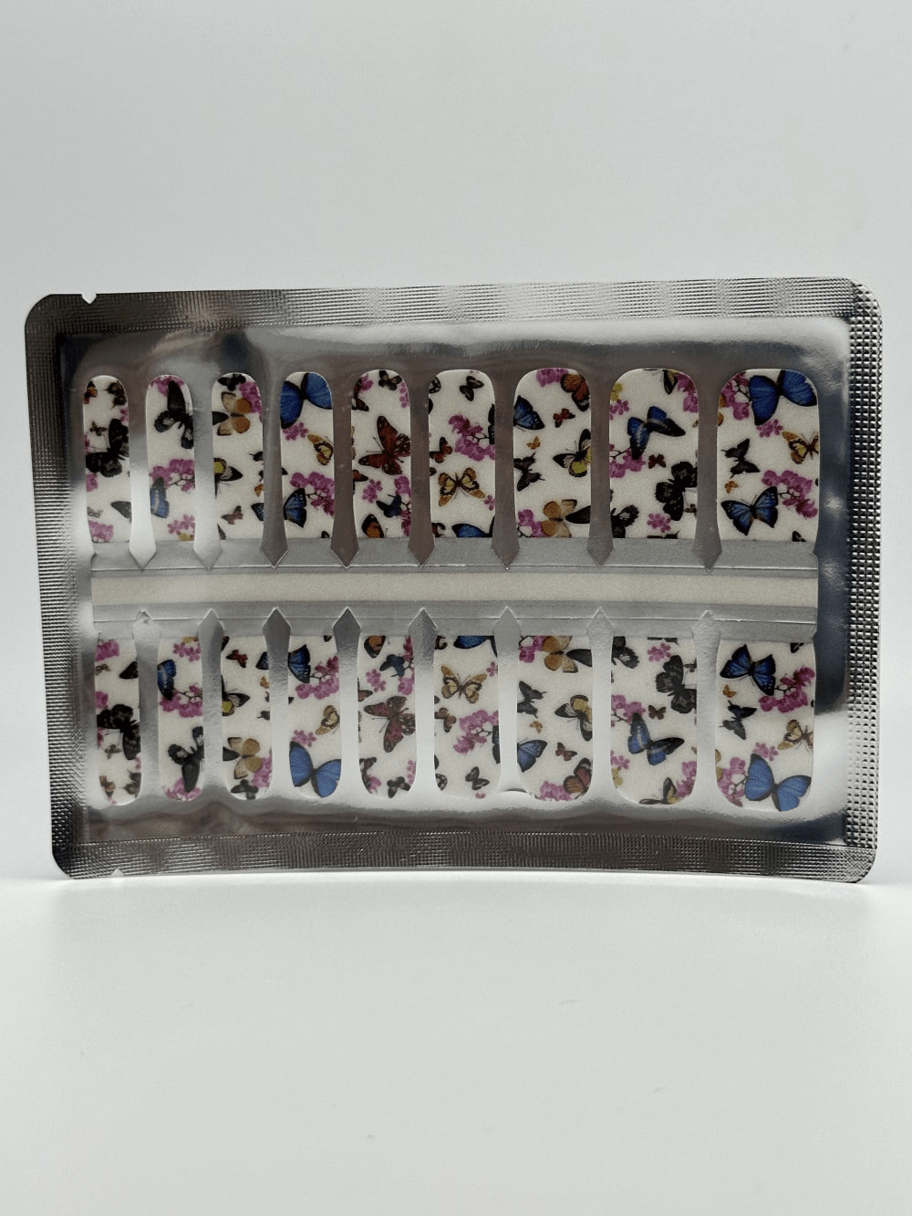 Kids nail wraps sheet featuring multicoloured butterfly designs in foil packaging