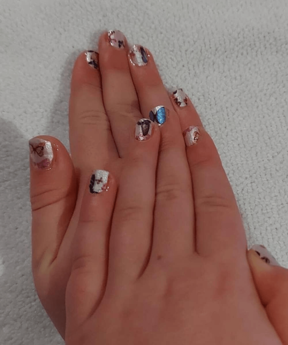 Two hands showing butterfly nail wraps with blue orange pink butterfly nail art