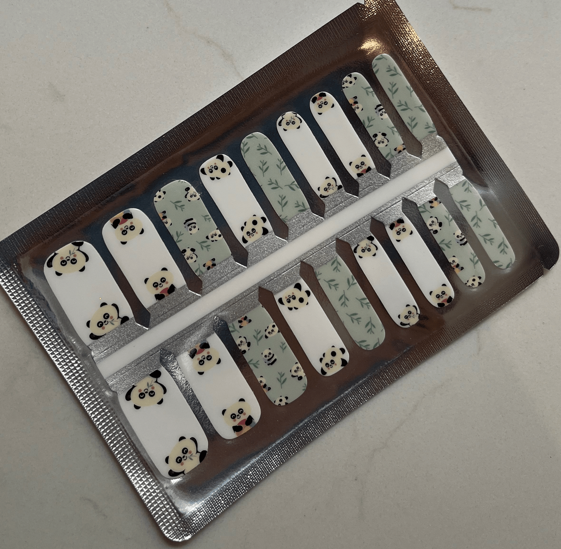 Complete set of panda kids nail wraps showing mint green and white kawaii animal designs