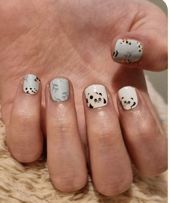 Cute panda kids nail wraps on small hand featuring mint green and white kawaii animal design