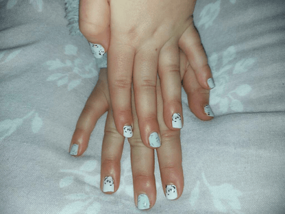 Both hands showing kawaii panda kids nail art wraps in mint green and white colours