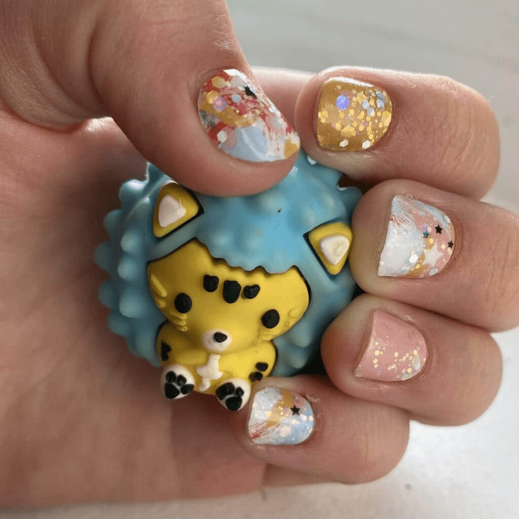 Small hands with panda nail wraps holding cute animal toy featuring mint green kawaii design