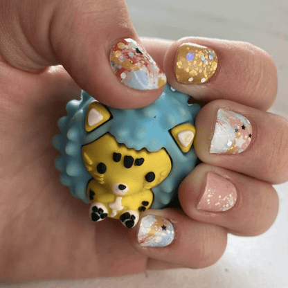 Small hands with panda nail wraps holding cute animal toy featuring mint green kawaii design