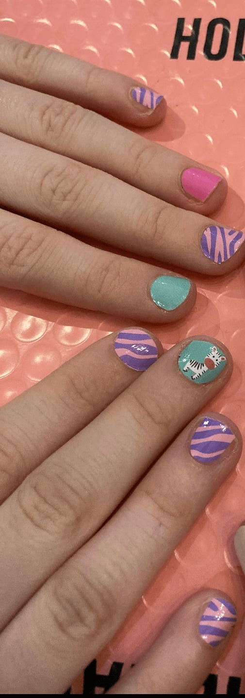 Kids wearing mint green and purple zebra nail wraps on small fingers