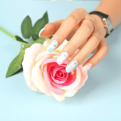 Kawaii llama nail art wraps applied on hand holding pink rose flower