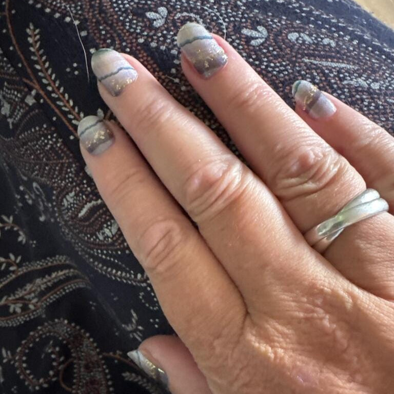 Applied grey marble agate nail wraps on hand showing natural stone pattern design