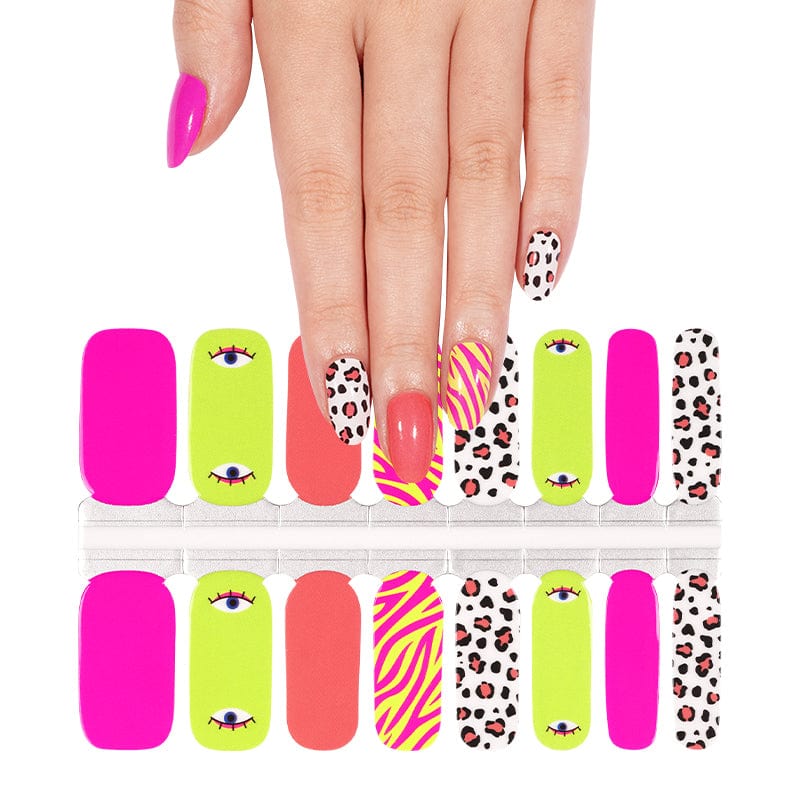 Hand wearing vibrant nail wraps with eye motifs zebra stripes and leopard print designs
