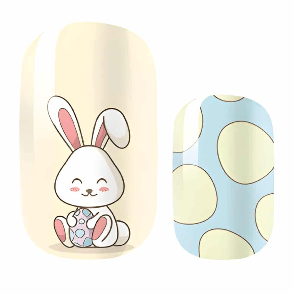Close-up of cute bunny nail wrap designs in yellow and blue with cartoon rabbit illustrations