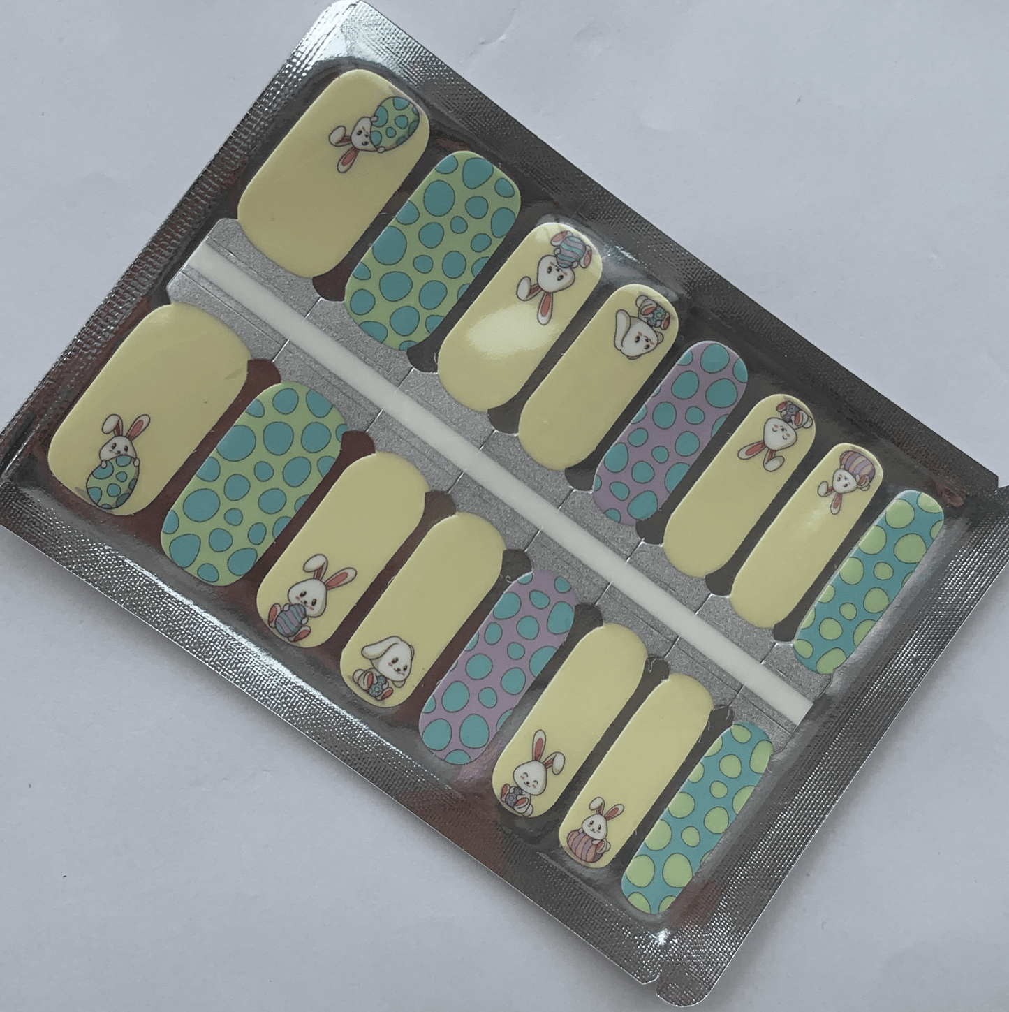 Non-UV nail wraps packaging showing blue and yellow bunny design manicure wraps in foil packet