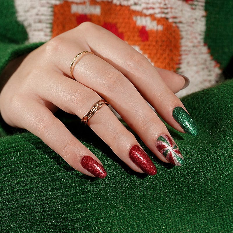 Christmas themed nail art with sparkly red green wraps and festive peppermint designs