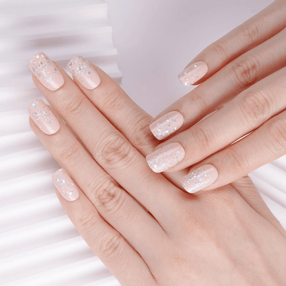 Pink glitter gradient nail wraps applied on hands showing sparkly ombre manicure