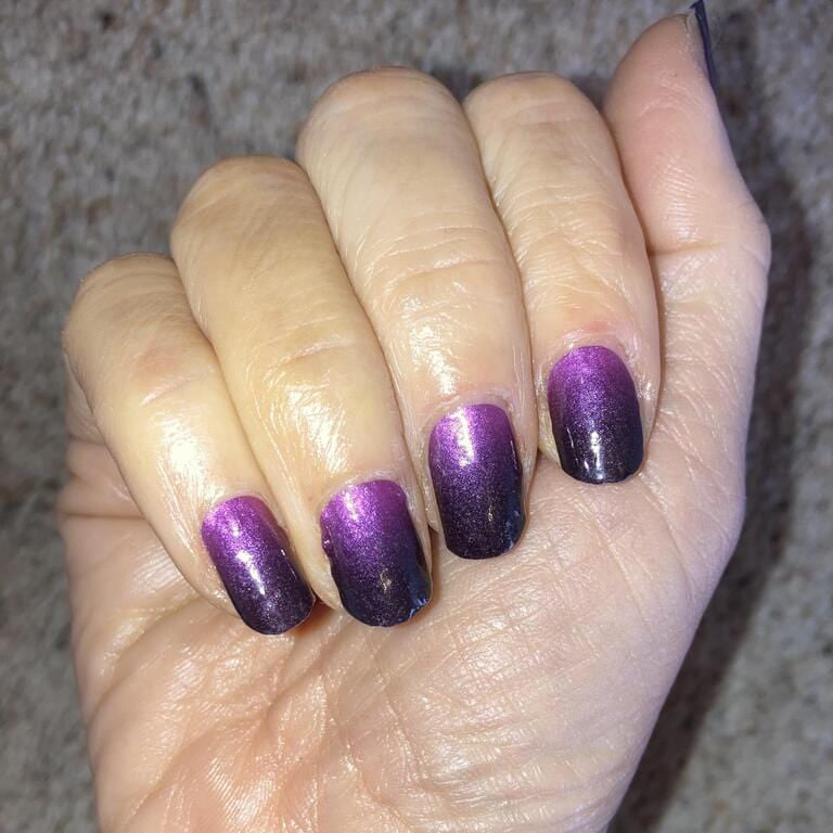 Glossy purple to black ombré nail wraps manicure on hand palm view