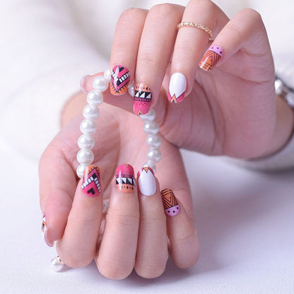 Colourful geometric nail wraps on hands with white pearl bracelet showing pink orange tribal patterns