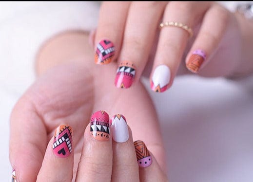Colourful tribal nail art wraps on hands with geometric pink orange patterns