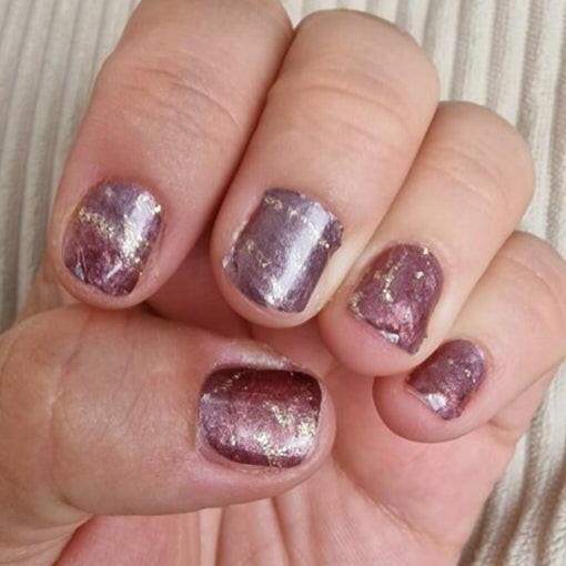 Purple glittery aventurine nail wraps with metallic sparkle finish applied on short nails