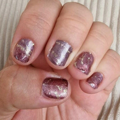 Purple glittery aventurine nail wraps with metallic sparkle finish applied on short nails