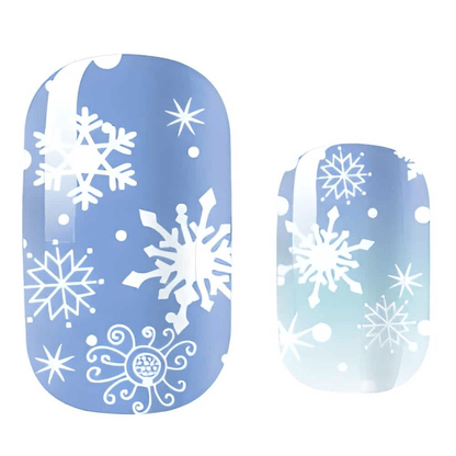 Blue winter nail wraps with white snowflake patterns for festive Christmas manicure design