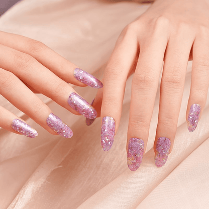 Both hands displaying purple glitter nail wraps with sparkly finish