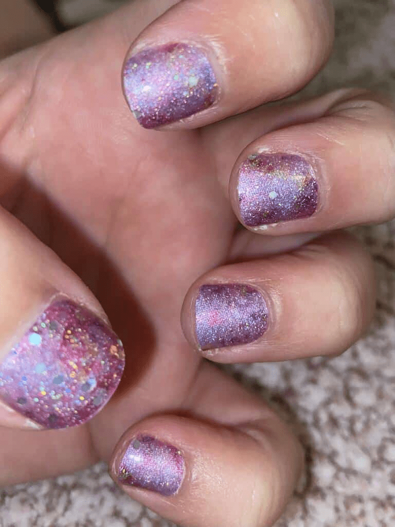 Close-up of purple holographic glitter nail wraps with iridescent sparkles on fingers
