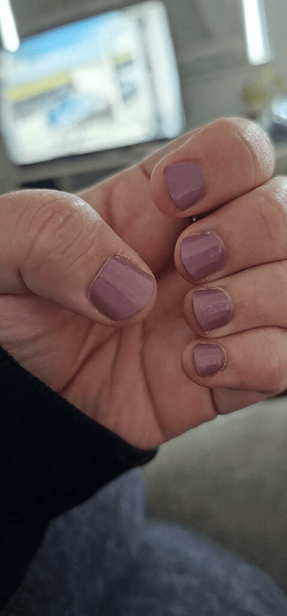 Blackberry purple nail wraps applied on hands showing glossy mauve manicure finish