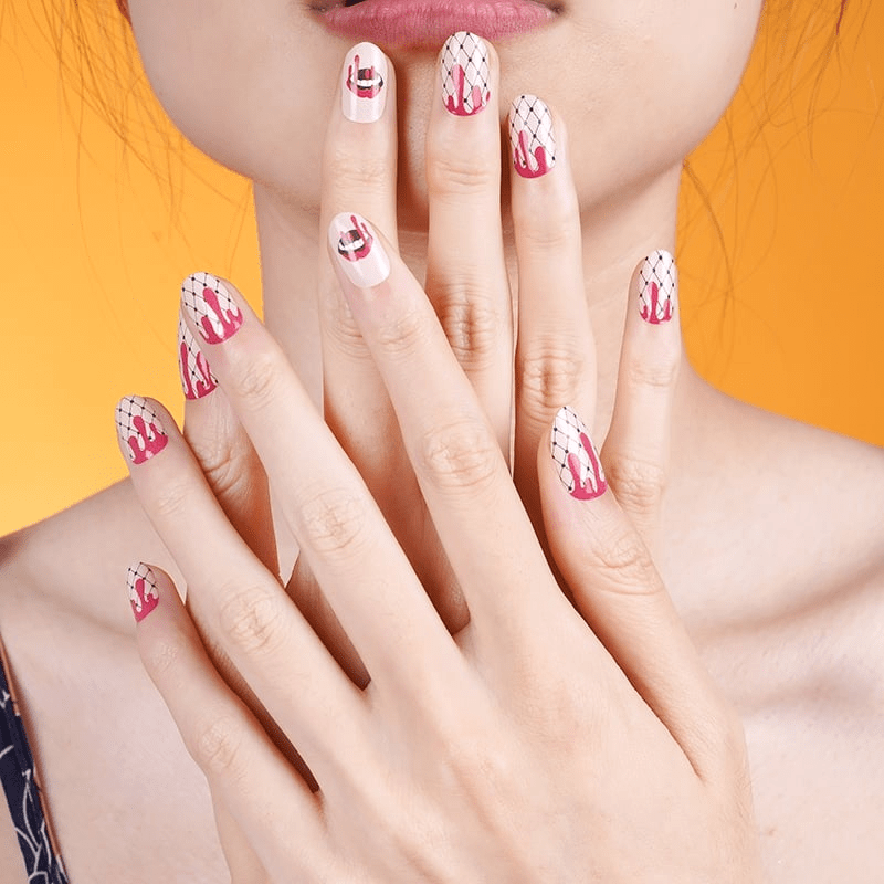 Gothic red blood drip nail wraps displayed on manicured hands against yellow background