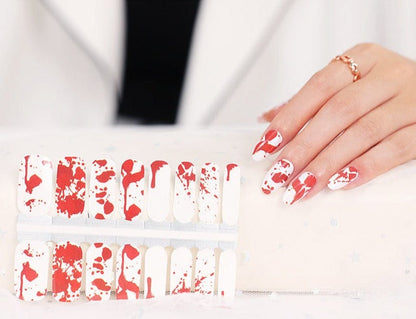 Red and white blood splatter nail wraps sheet with matching manicured nails