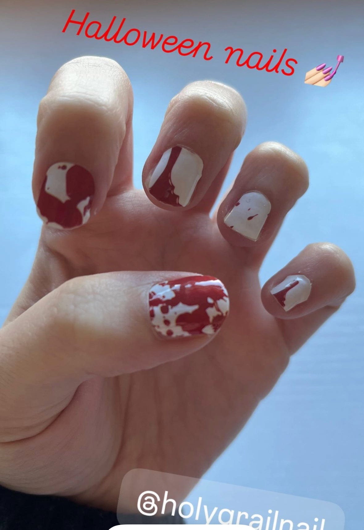 White nails with red blood splatter pattern nail wraps on hand